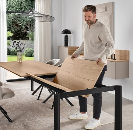 Modern extendable dining table with butterfly extension mechanism, showing easy tabletop expansion and contemporary wood finish in a stylish open-plan kitchen and dining space by 21 Kitchens