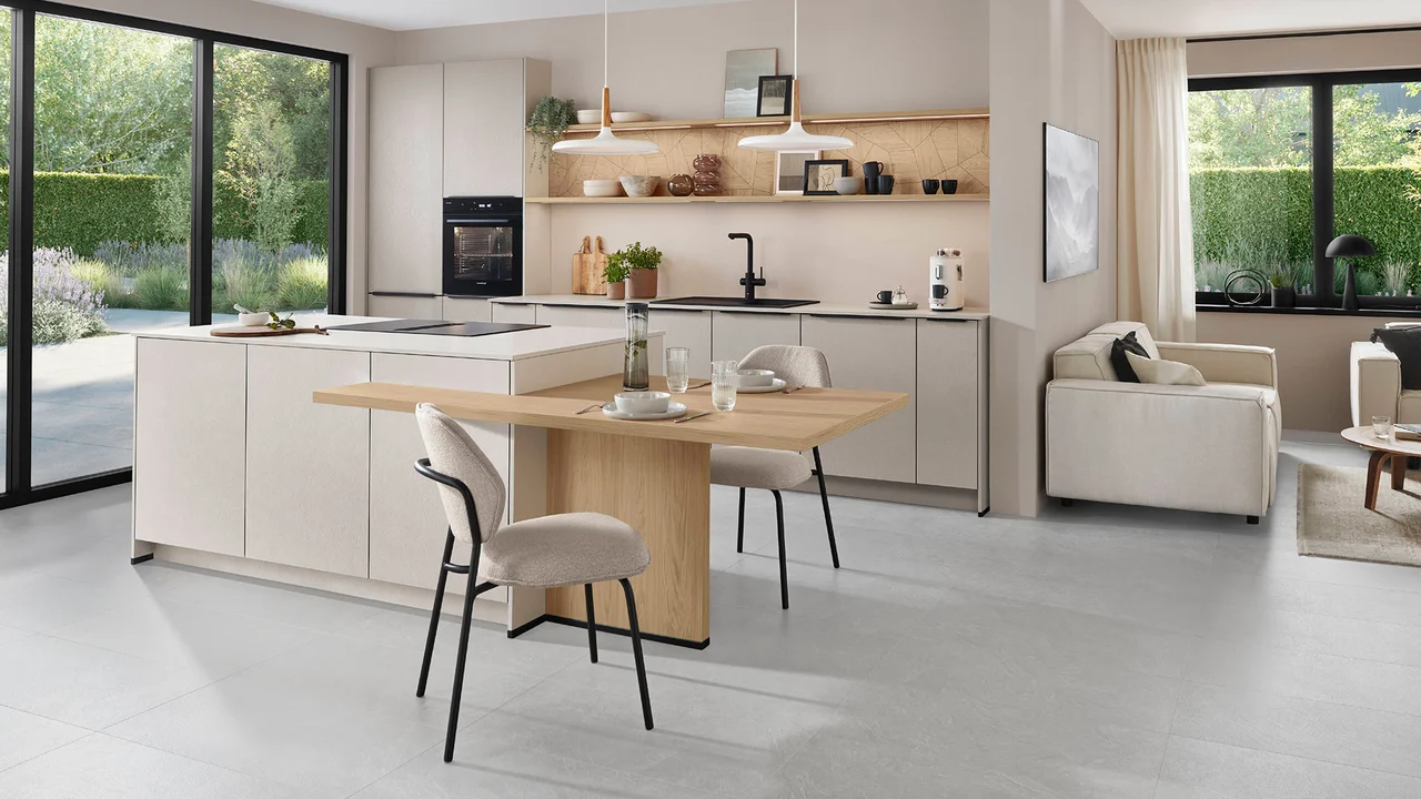 Open-plan kitchen with textured sand cabinets designed by 21 Kitchens Ayrshire