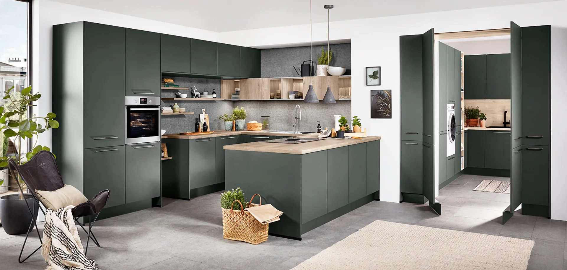 Soft green kitchen with concealed utility room entrance by 21 Kitchens Ayrshire