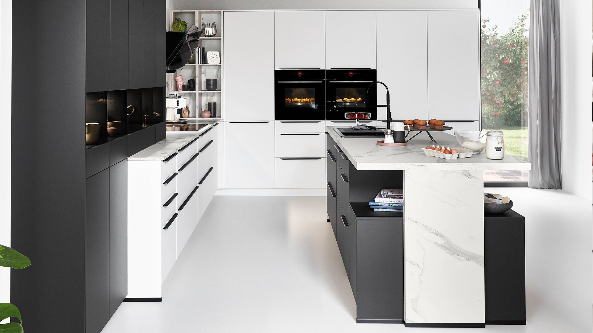 Contemporary white kitchen with marble-effect island, integrated storage and premium appliances by 21 Kitchens Ayrshire.